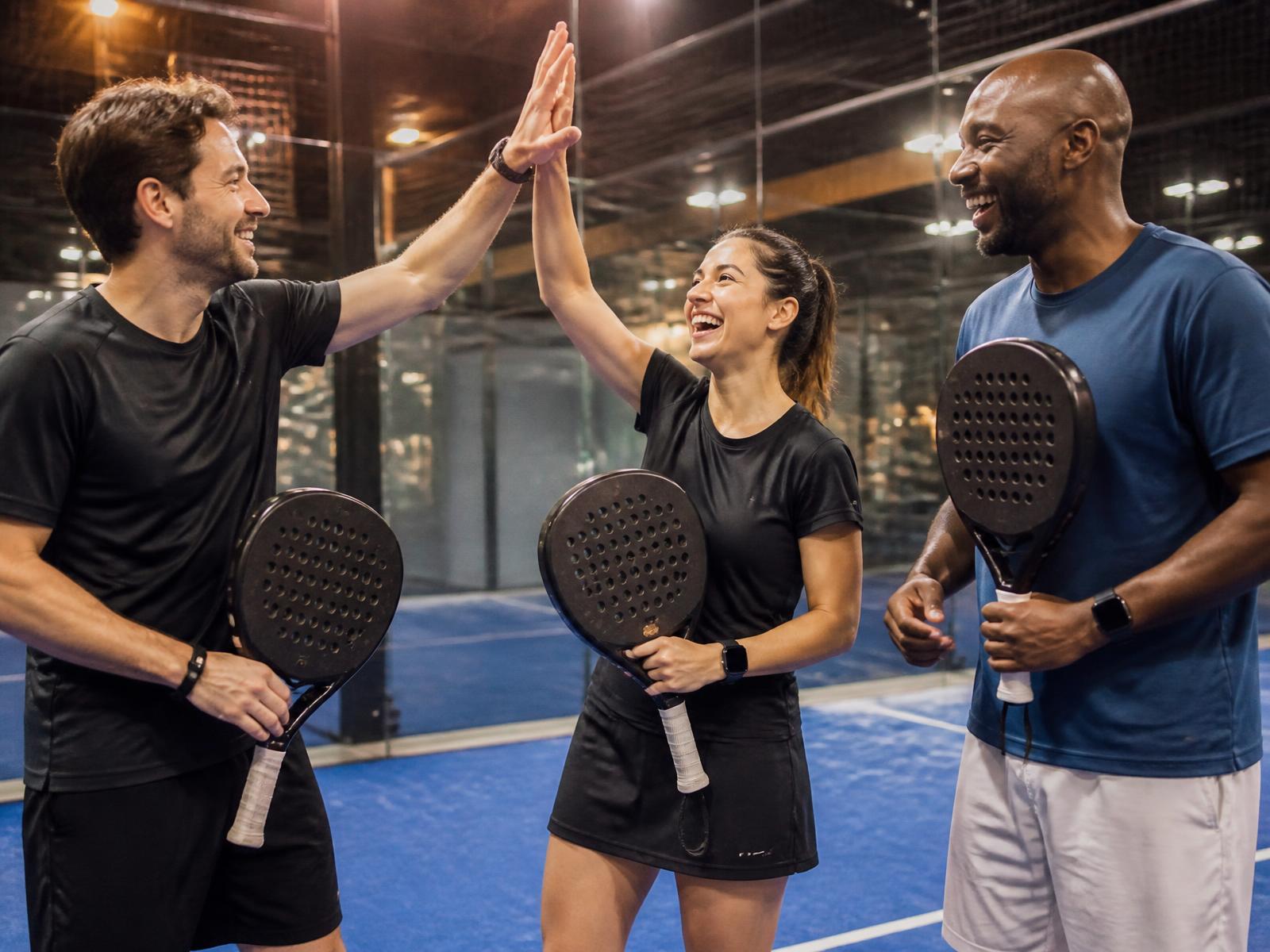Colleagues of different ages and abilities together after a padel event