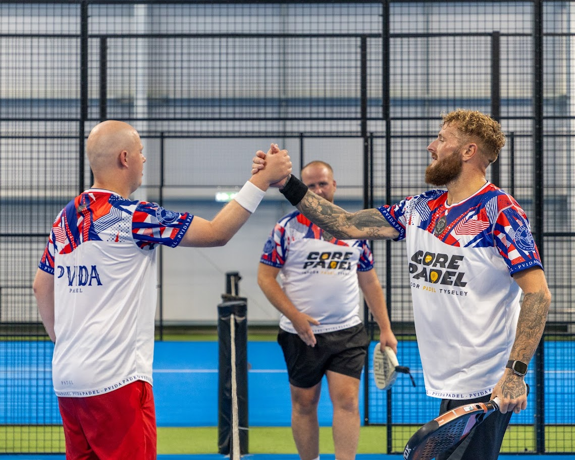 Two players shaking hands across the net after a match